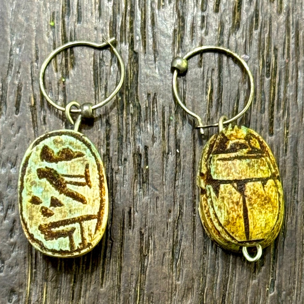 Vintage Egyptian scarab drop hoop earrings with hieroglyphic script etching.